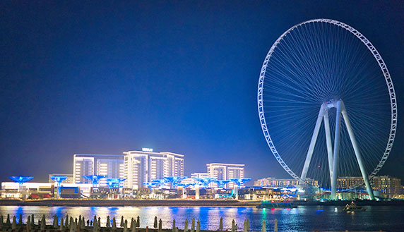 Dubai Ain Ferris wheel and city skyline at night