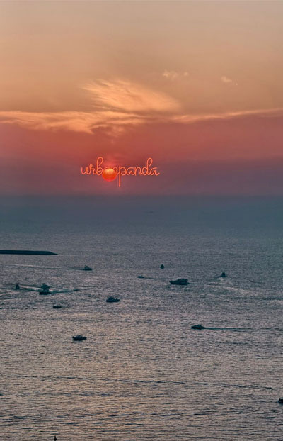 Sunset view over the sea with boats in Dubai